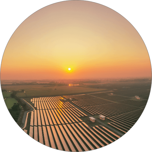 Solar panel system on grassland with sunset in circle - RA-ESG